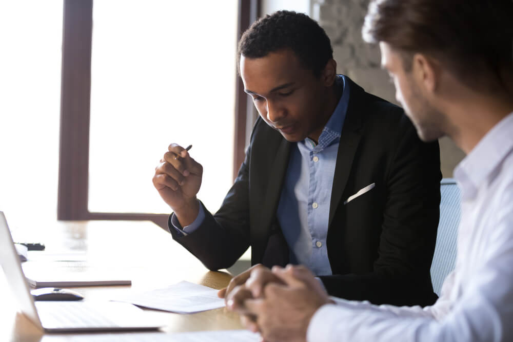 Acquiring a work from home franchise A man is signing a franchise agreement