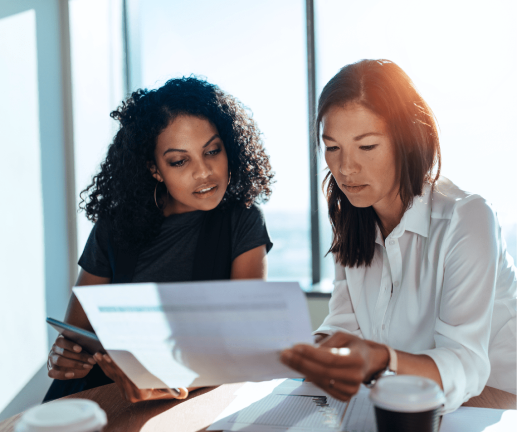 Two women reviewing a document | Franchise Local Two women reviewing a document | Franchise Local
