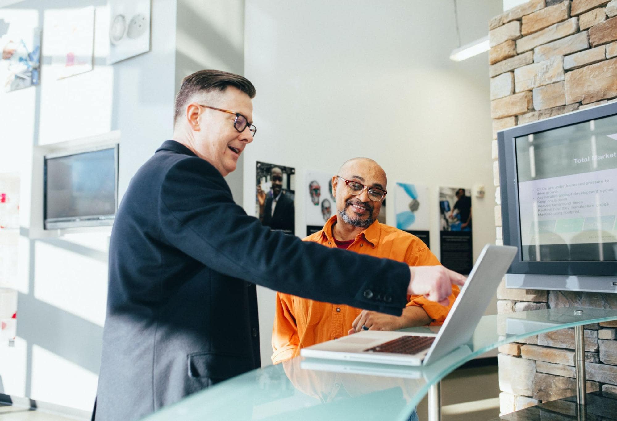 Two men working by a computer