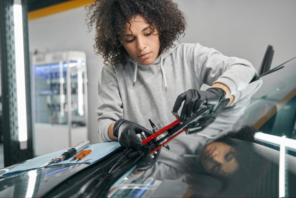 Woman repairing windscreen