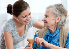 Elderly woman and carer